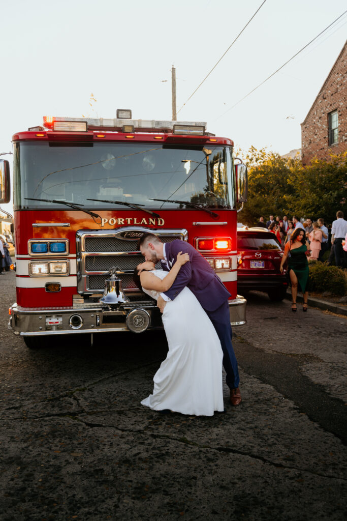 bride and groom kiss in front of a portland fire truck
