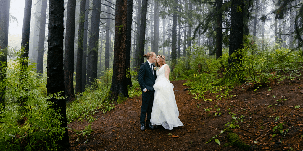 bride and groom standing in a forest in portland